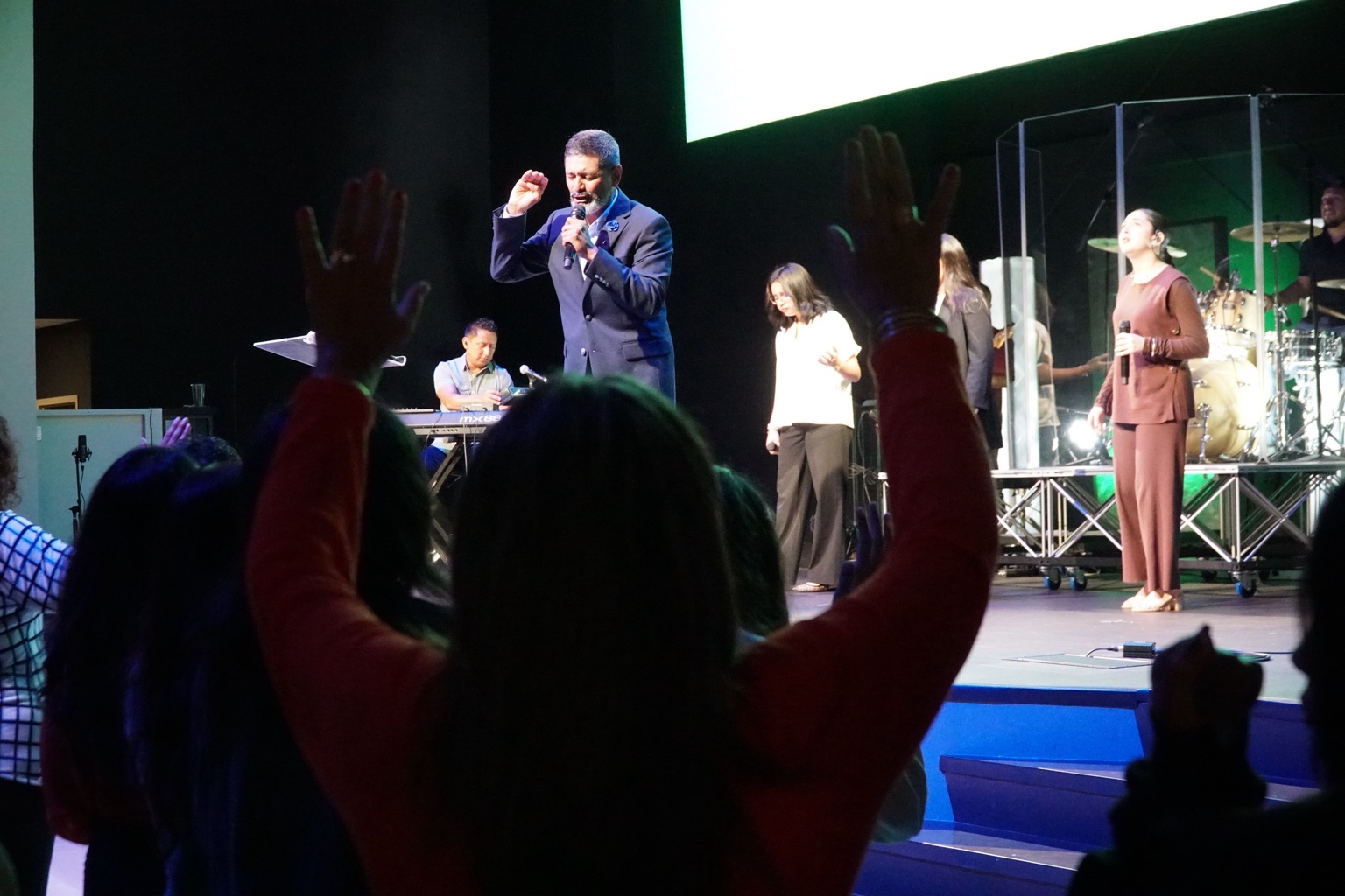 Jose Luis Urrutia ministering in prayer with a congregation